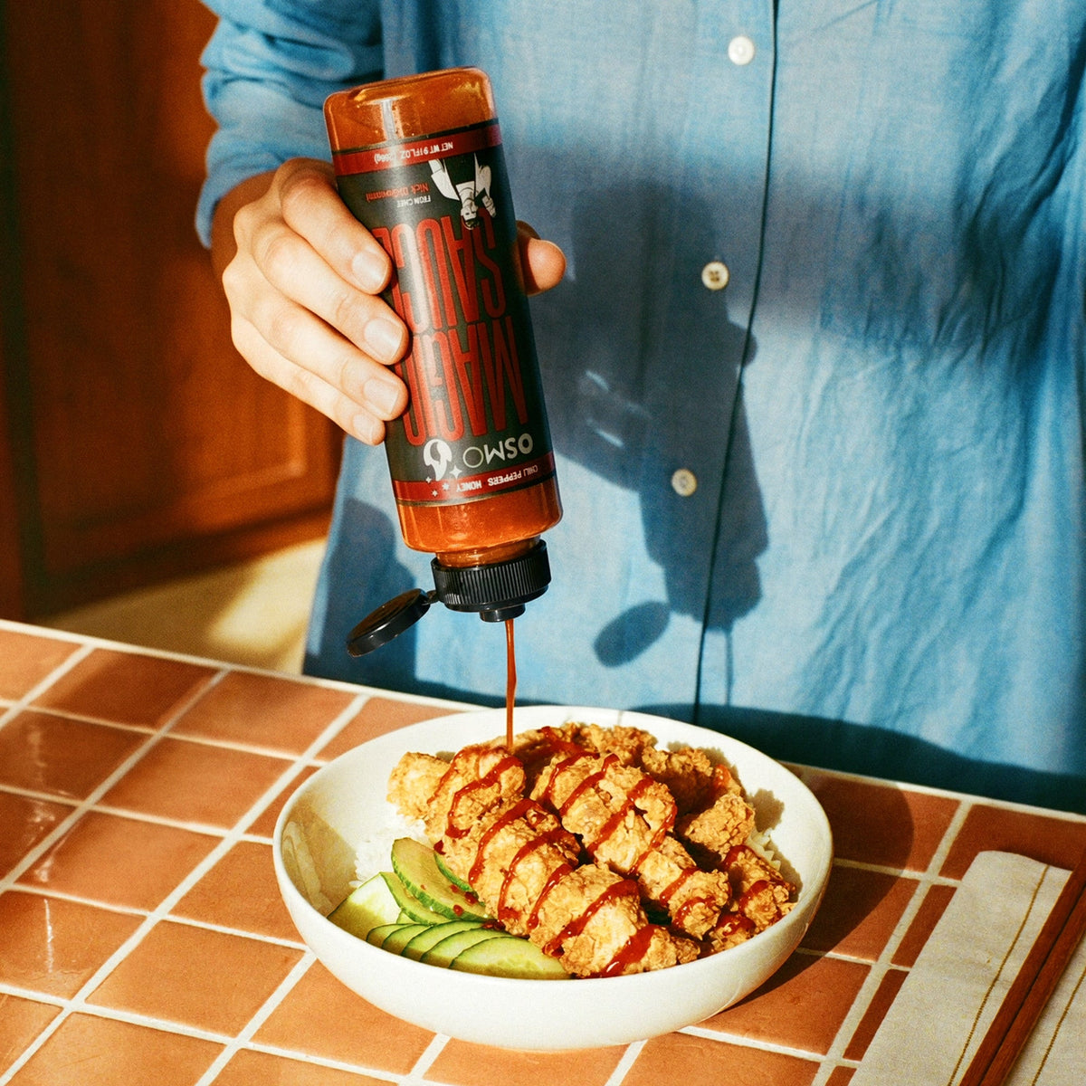 Pouring Magic Sauce over fried chicken