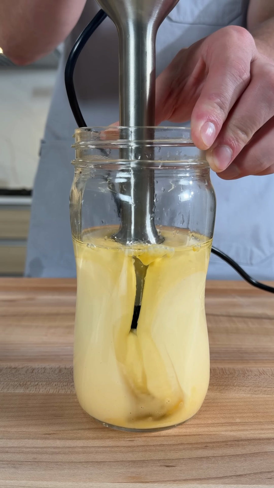Nick lifts the immersion blender as the mayonnaise becomes thick and creamy.