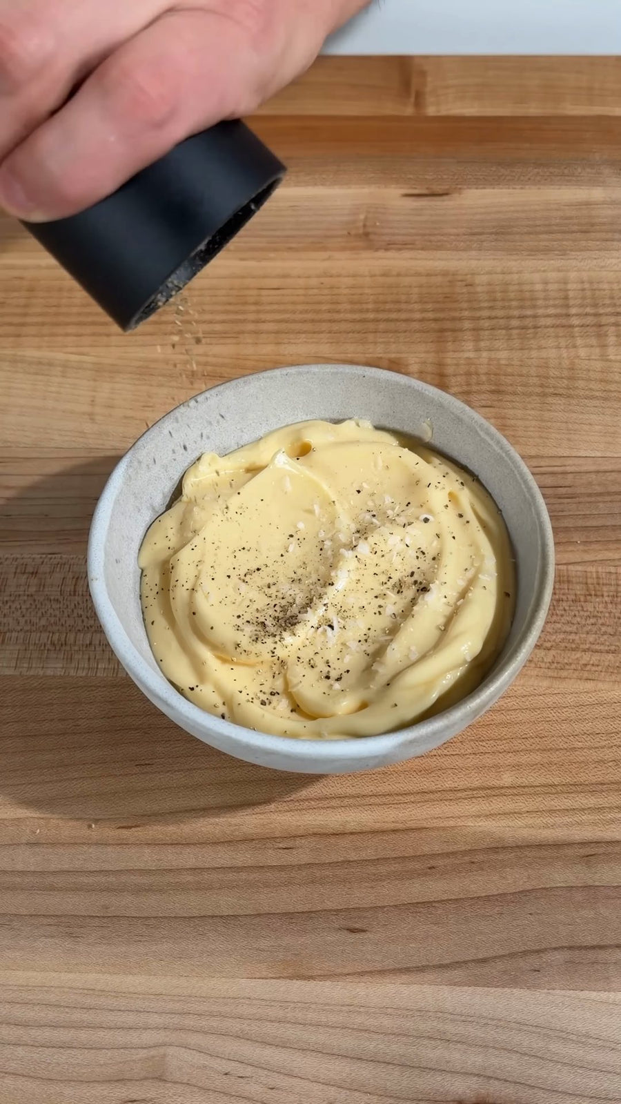 Nick seasons the finished homemade mayonnaise.