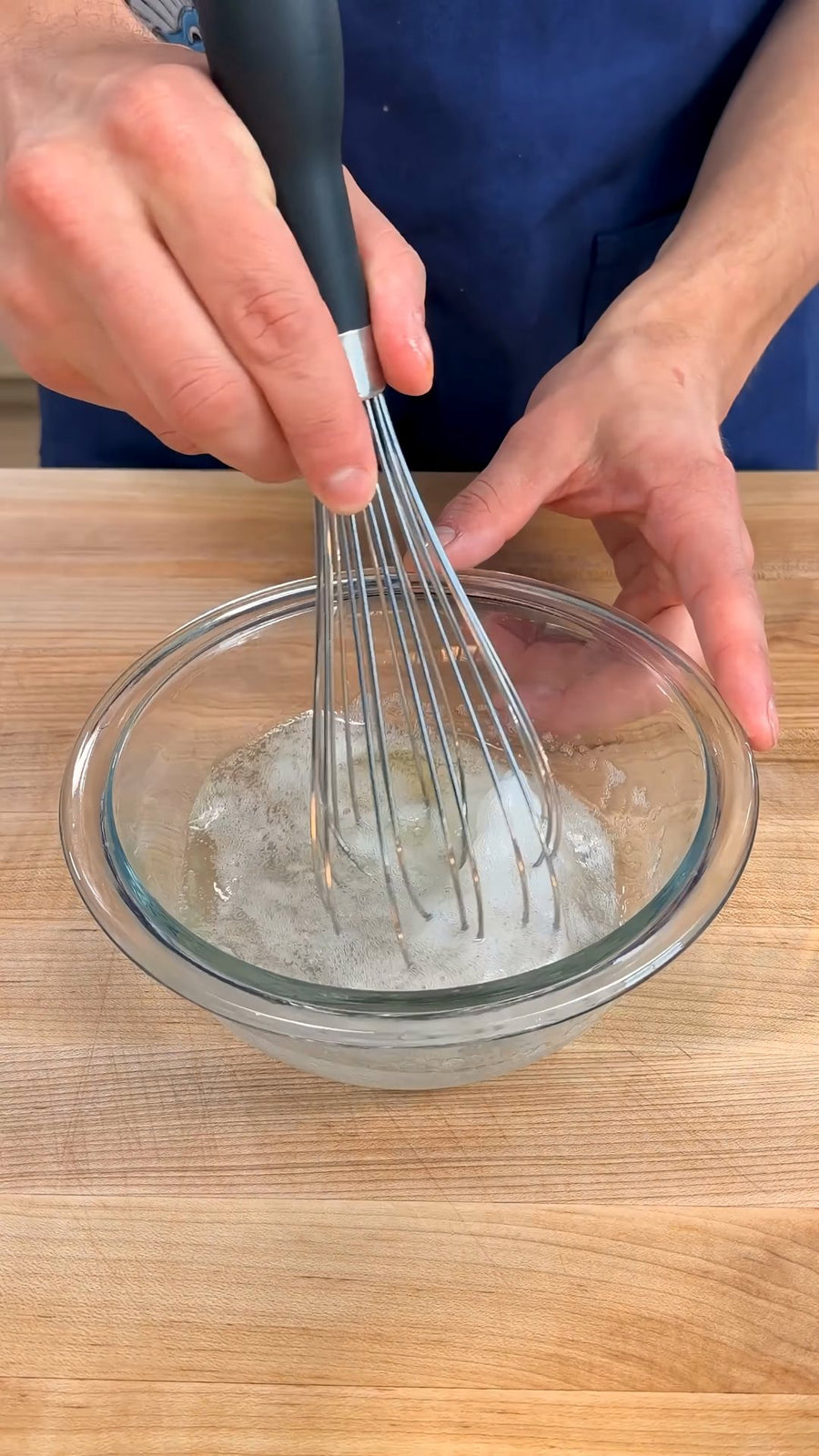 Nick whisks cold seltzer and egg white in a bowl.