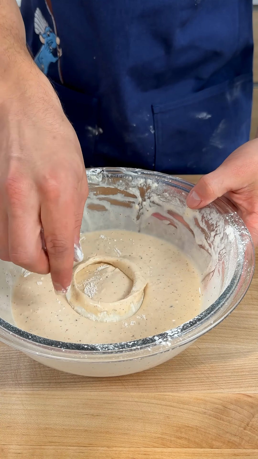 Nick dips an onion ring into the cold batter.
