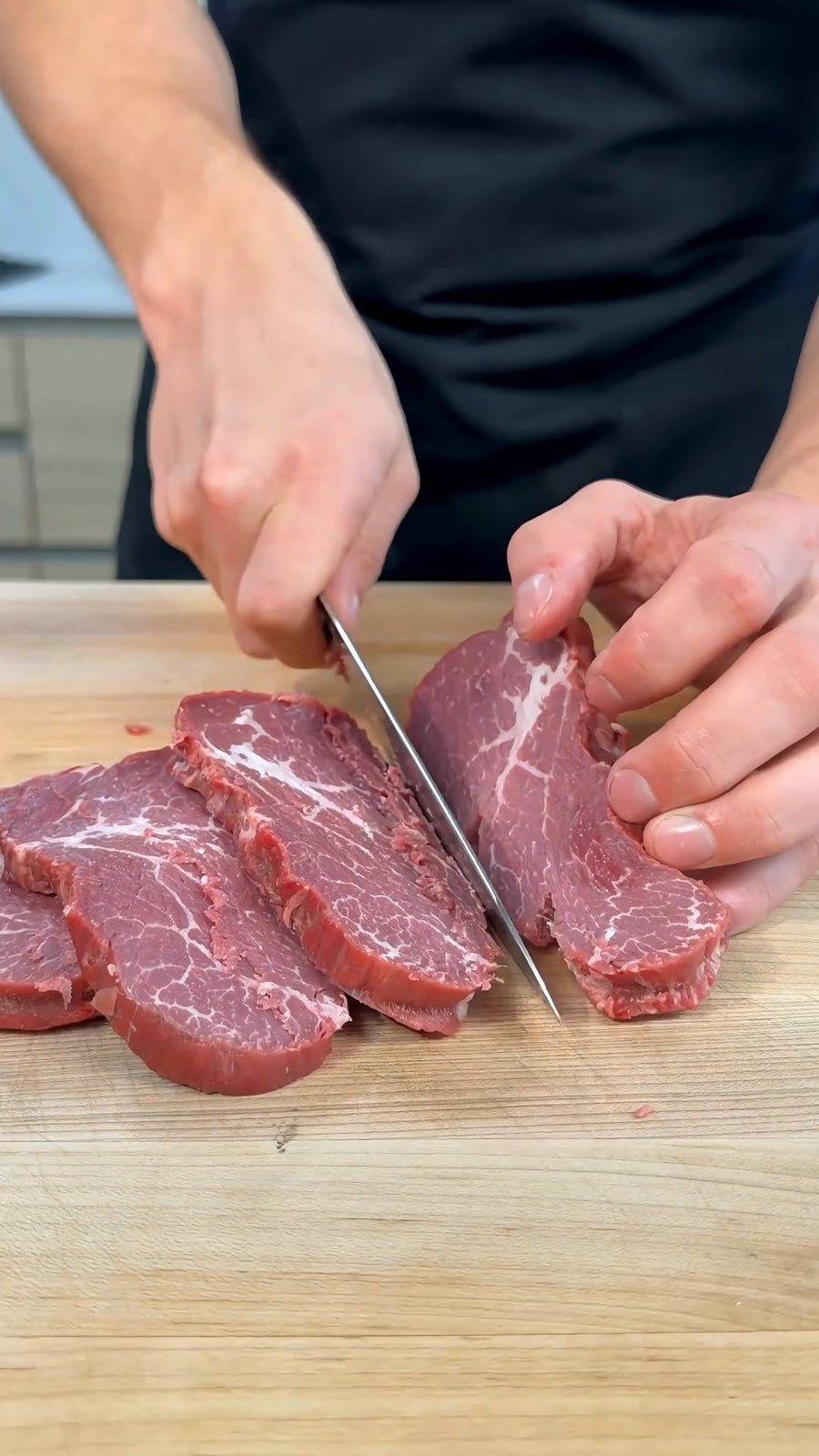 Nick slices the chilled tenderloin before cutting it into even cubes.