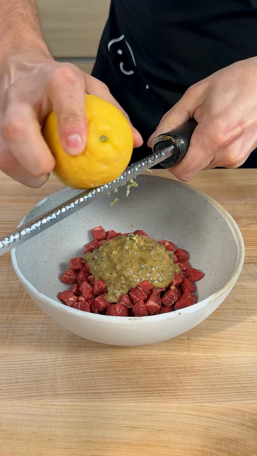 Nick adds fresh lemon zest to the diced beef and dressing.